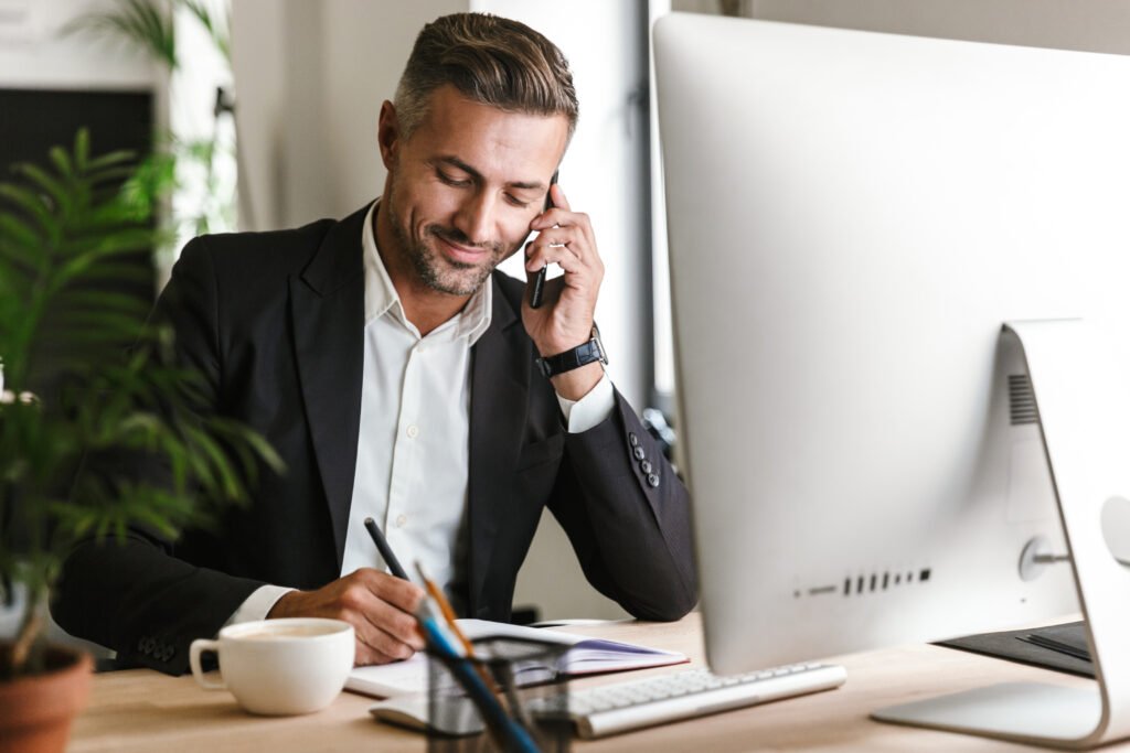 man on the phone looking happy about applying for transition finance